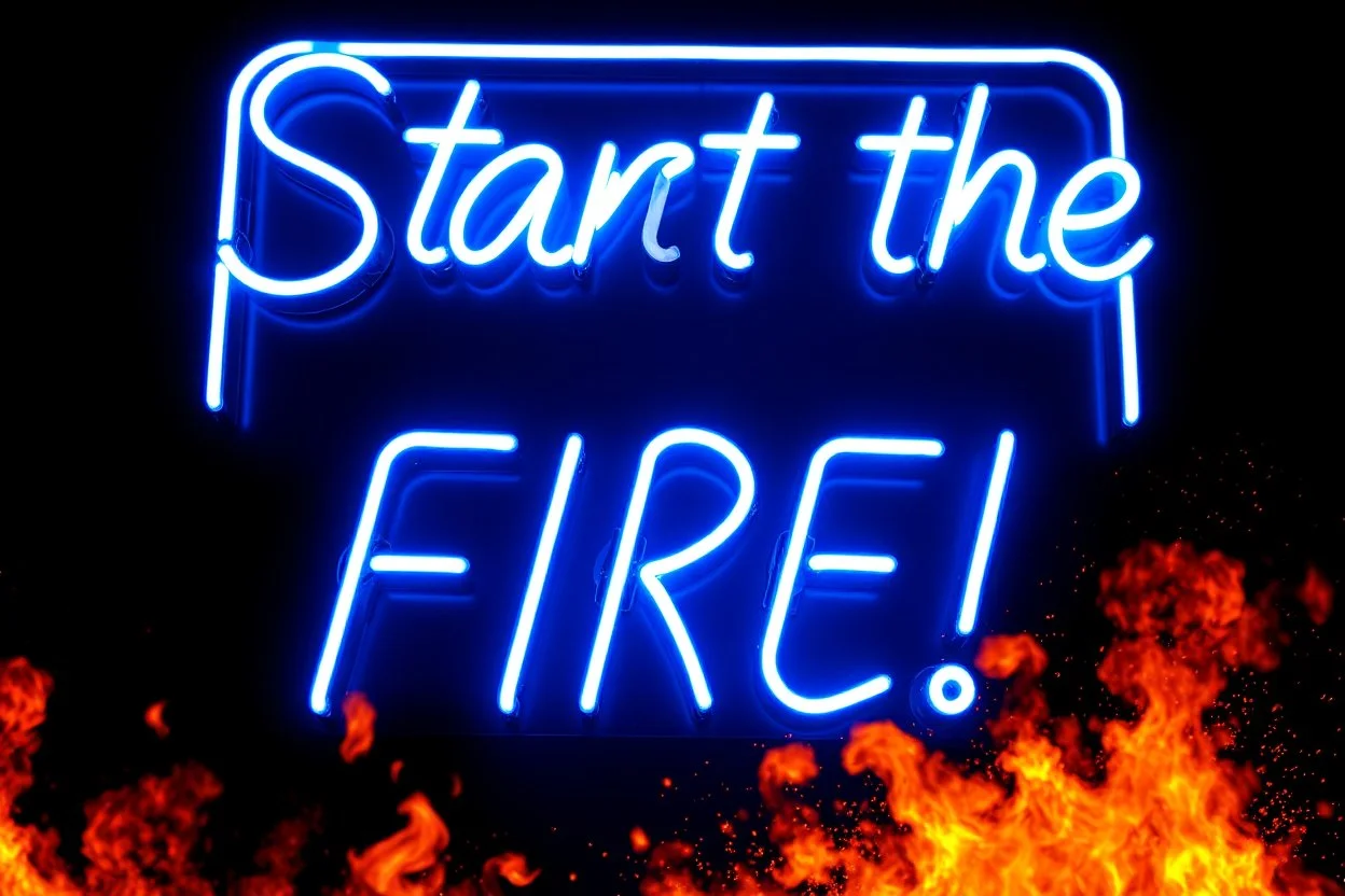 a very big blue whita neon sign that say "Start the FIRE!" , black background, fires and sparks, explosion