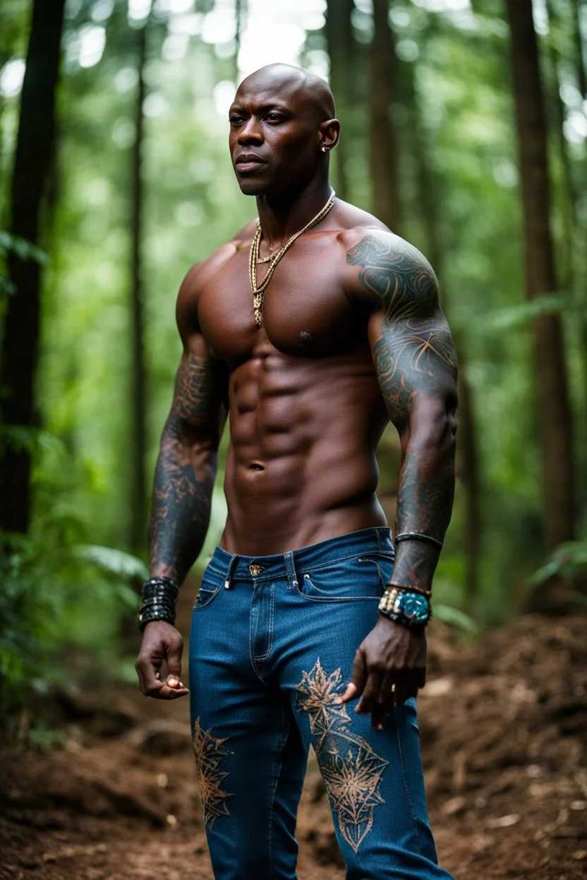 Alimi Ballard as muscular man bald with tribal tattoos wearing jeans and a teeshirt in a forest