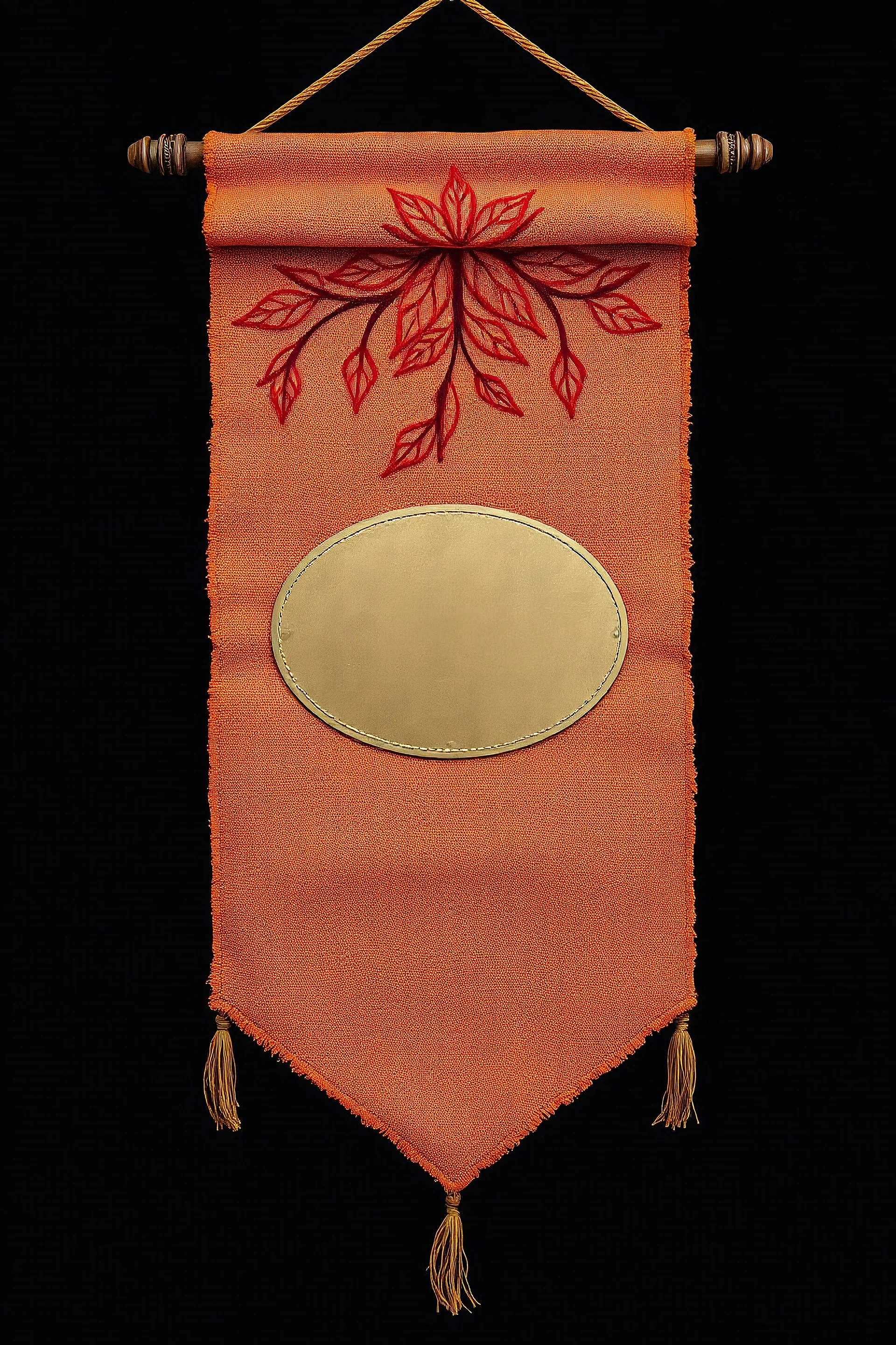 an autumn colored textured cloth banner hanging with embroidered ornamental leaves, blank oval brass engraving plate in middle, banner is downward pointed bottom, on dark background