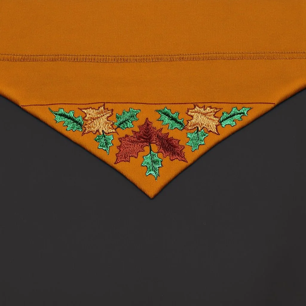 an autumn colored textured cloth embroidered with ornamental leaves and cattle, pointed bottom, on darker textile background, embroidered text across top, western textile art design