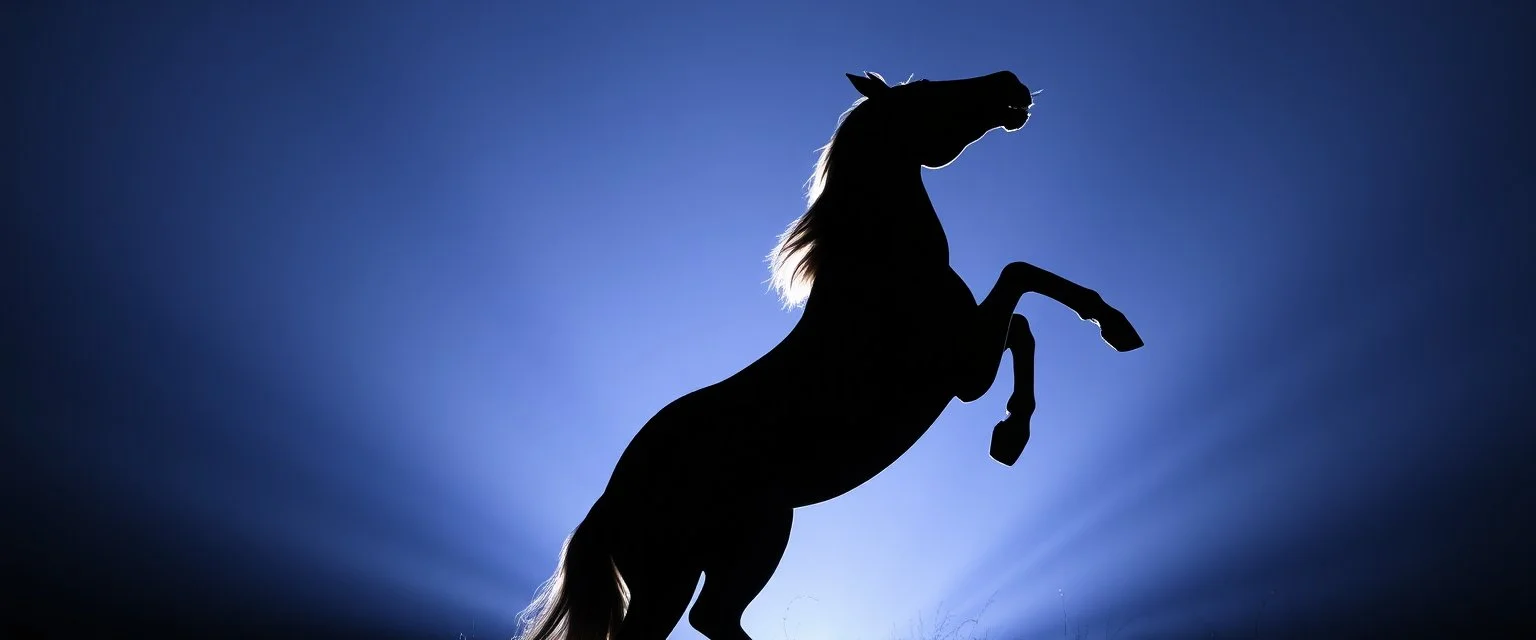 silhouette of a horse rearing up(outlined by lighting)