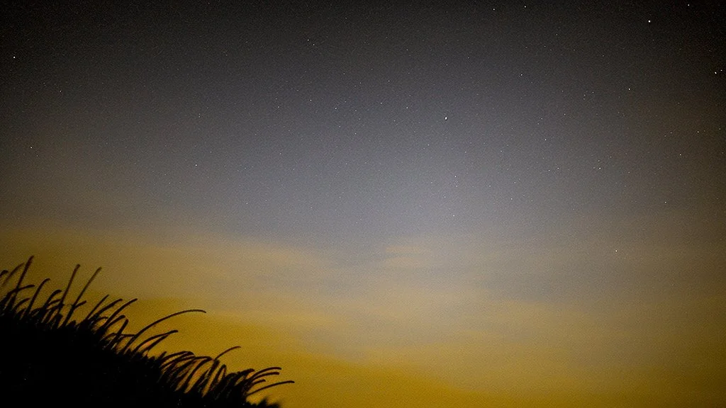 Comet in the night sky over the plain