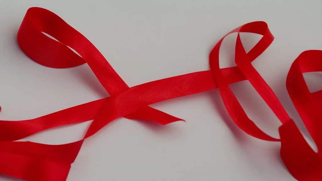 packet of red pills, a torn red ribbon, on a white background