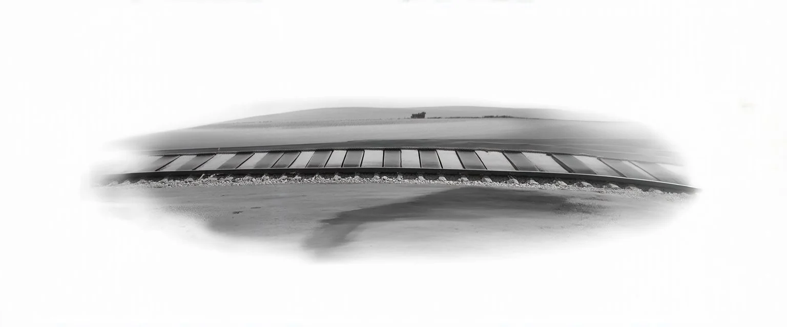 side of old western railway track, overcast sky, fields in background, from photo reference