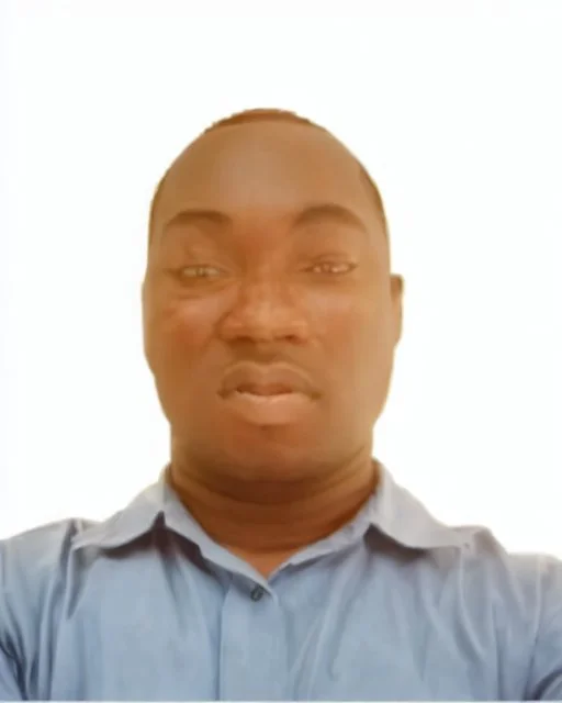 passport picture of black man with a brown shirt and hidden facial mark