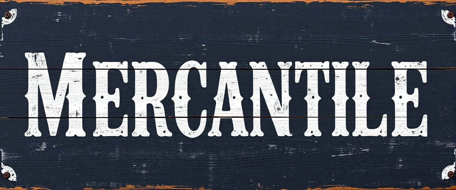 fill composition with large and wide historical hand painted old western sign that reads: "MERCANTILE" white on black with inset white stripe boarder aged paint on wood sanserif