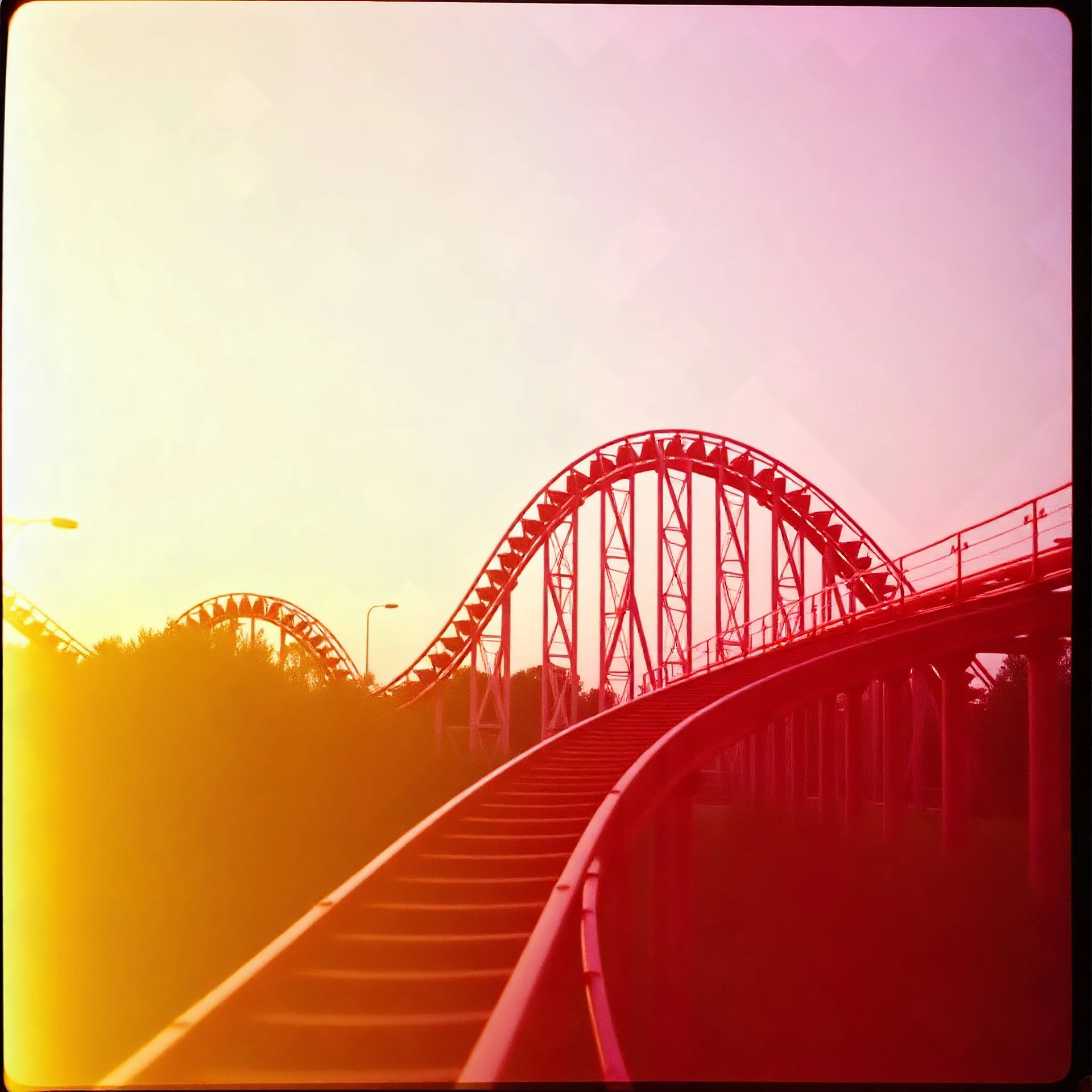 kodachrome of a roller coaster, evening light, relaxing, vintage, pink and yellow