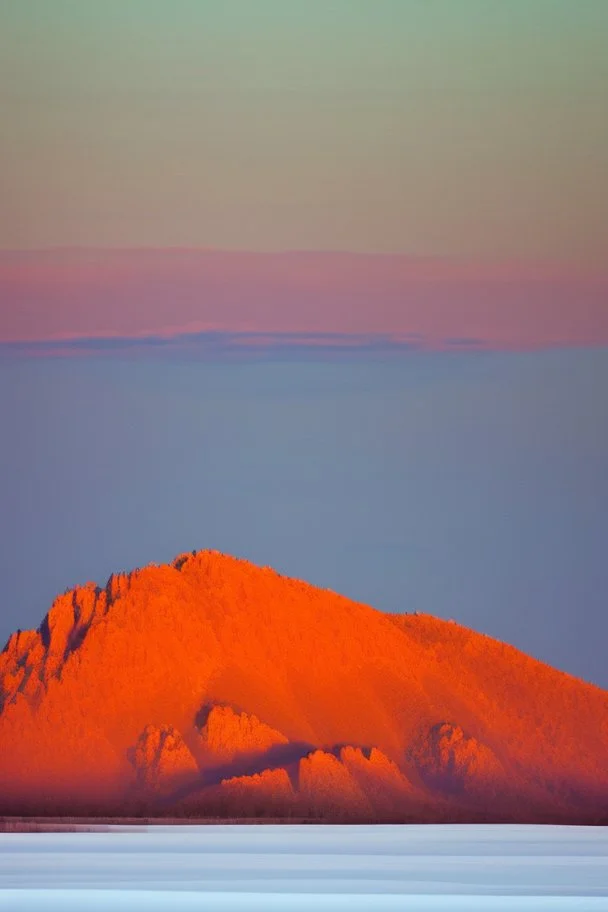 big rock mountains with and orange dawn sky with no clouds. mountains closer to the camara