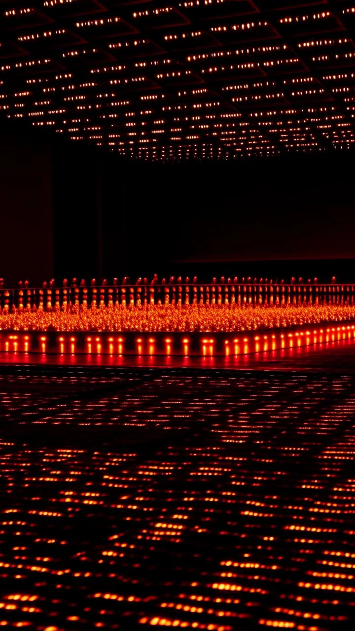 Track of oil with runners made of lights, in the background the crowd is burning, in the style of Donald judd