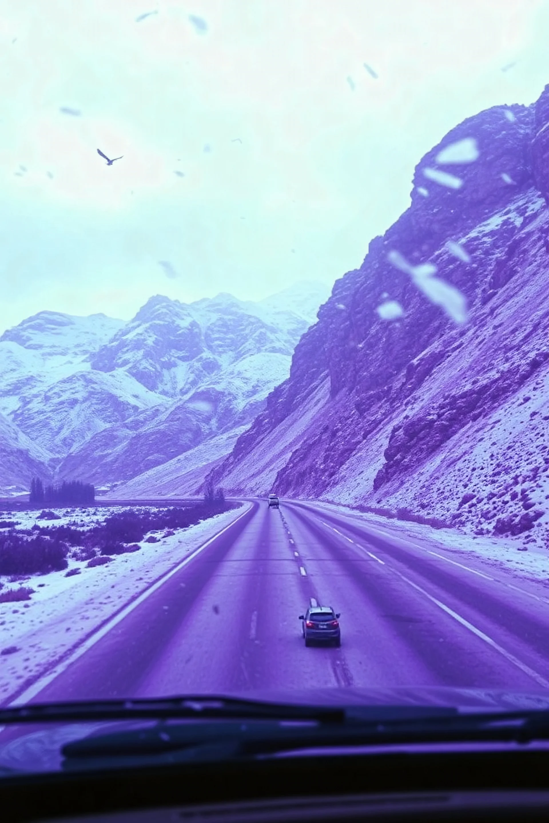 surreal purple plastic mountain road seen through a dirty truck front window, dirty blue snow and wind, autochrome