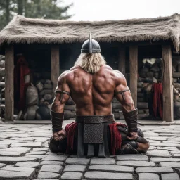 muscle viking back on his knees on a plazza, hands in the viking village, ready to have his bloody back opened for execution and lungs open to the outside: this is the blood eagle ritual execution