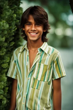 15 year old young boy with lightly tanned skin and medium length brown hair, smiling, wearing a shirt, inside