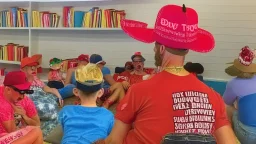 many men wearing red trucker hats enjoy the drag queen story hour