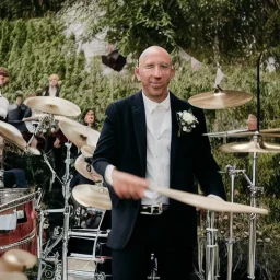 Marc Pellizzari playing drums at his own wedding