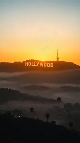 A realistic sunrise view of the Hollywood sign with golden light gradually revealing the letters, while the sprawling city of Los Angeles below is shrouded in early morning mist, capturing the peaceful yet grand atmosphere. Higher gradent or cinematic look