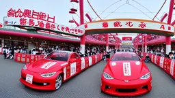 A Tesla's 'Model S Plaid' is racing at top speed, across the 'Nagashima Spa Land', in Kuwana, in Japan. CINEMATIC. WIDE ANGLE LENS.