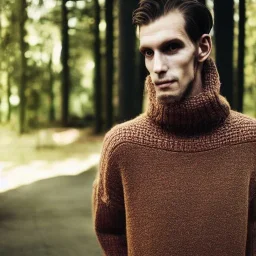 a full picture of a tall skinny man with light and greasy hair wearing a woolen sweater outside in nature