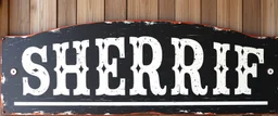 large and wide hand painted old western sign that reads: "SHERRIF" white on black with inset boarder stripe in white aged