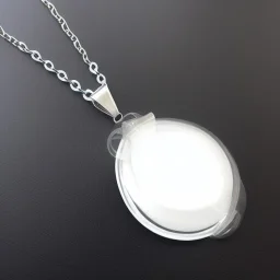 Clear polyester necklace with a chunky silver pendant in the shape of a key