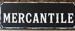 fill composition with large and wide hand painted old western sign that reads: "MERCANTILE" white on black with inset white stripe boarder aged paint on wood sanserif