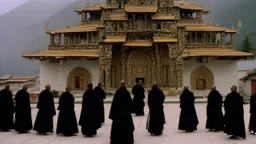 black robed monks standing before a massive monastery