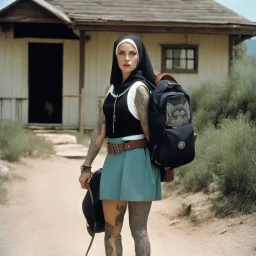 (high res photo by Russ Meyer) Clara, the tattooed free spirit, gangsta nun, burdened with two backpacks, one on her back and one on her front. Is she moving from one house to another or embarking on a vacation to camp? Difficult to say. The constant pressure to keep those worlds coming. The weirder, the better. The weight of the backpacks, the burdens she carries, both physically and metaphorically. Clara seeks solace in the freedom of movement.