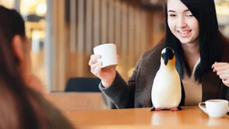 young woman talk to a penguin in coffee-shop