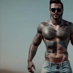 A waist to head shirtless muscular man with tattoos all over him and lots of chest hair, and ripped jeans. He has sunglasses, a towel draped on his shoulders, and a blonde moustache