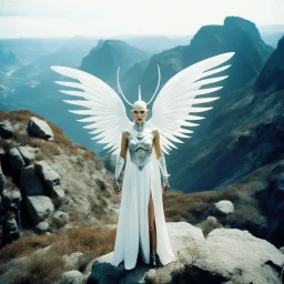 deity insanity: deicide in a Surreal, 35mm film photography featuring a futuristic scene, a woman with 2 big and 2 smaller alien eyes located on the temples, white skin and a bald head, 4 mini wings behind the ear looks like darts, 2 on each side, four wings and 4 eyes located horizontally, and 4 arms. standing on a cliff of mountain. Big waterfall behind, and crystalized rhombus textured pyramidal shining glowing building