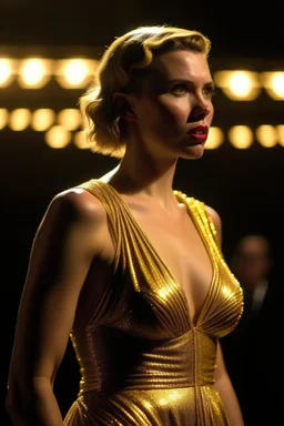 Scarlett Johansson, wearing a gold lame dress with spaghetti straps, standing against a dark background with stage lighting