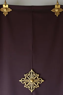 darker textured hanging fabric background with decorative brass corners at top, and a wide brass decorative element clamped across the bottom