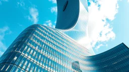 A futuristic hyperboloid skyscraper with a twisting façade, where the building’s structure curves inward and outward in a continuous, graceful helix. The reflective glass exterior mirrors the sky, while the hyperbolic curves create an illusion of constant motion. The dynamic, tapering form rises to an elegant, spire-like point. Award-winning photograph.