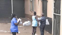 woman hands the bundles of cash her mobile phone provider's located across the street from a high crime area