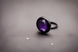 небольшое чёрное кольцо с лиловым камнем на нем выпало на пол.