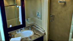 hotel bathroom with. hole in the wall spraying water all over with broken mirror and sink