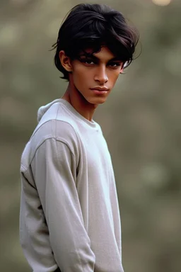 Appearance: Ari has a mixed-race skin tone with a light brown complexion. He has dark hair in a page boy haircut, and his hair length could be somewhere in-between long and short. His face is thin with high cheekbones and dark eyes that are often full of emotion. He stands at around 5 feet 7 inches tall, with a lean build that suggests he doesn't engage in a lot of physical activity. He is of average attractiveness.