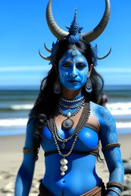 A photo of a blue skin Hindu goddess with painted blue face and body skin, wavy black hair deer antlers standing on a sunny beach