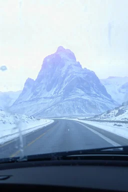surreal purple plastic mountain road seen through a dirty truck front window, dirty blue snow and wind