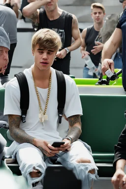 Justin Bieber holding a phone and crying