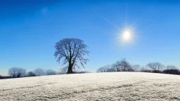 a single ivory hill with the blue sky and the icy sun behind it