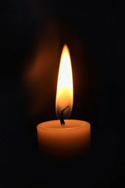 Close-up of the candle flame that glows unnaturally bright, mysterious aura, soft