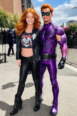 Debby Ryan, smiling, Heavy Metal t-shirt, Black Leather biker's jacket, Black leather pants, Platform boots, midday, bright sunlight, extremely colorful. Big, fluffy hair, Debby Ryan has Auburn Red hair, green eyes, She is standing next to ((THE PHANTOM, an extremely muscular man who wears a one-piece, formfitting purple body suit with tribal designs lightly woven into the fabric. He also wears a cowl, eye mask, black boots, black gloves, double holstered pistol belt