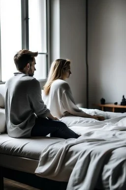 sitting on a bed with someone sleeping