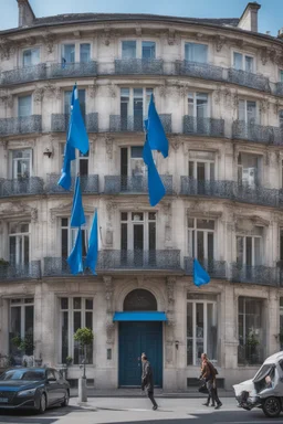 A full street in a big city with frech style building. The street is filled with blue flags