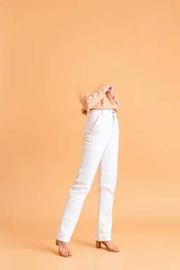 simple background a beautiful young lady wearing pretty pants and blouse standing gracefully