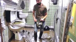 russian spasmo man stands on the sink while sewage floods bathroom and hallway because of boys playing with clogged toilet.