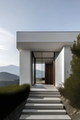 Acceso principal de una casa mínimalista con vista hacia unas montañas