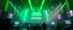 giant industrial halls green tube lighting choir vocals ancient-celtic-meets-cyberpunk imagery synchronized mechanical drumming flickering CRT screens saying "PSYSTEMA STABILE"