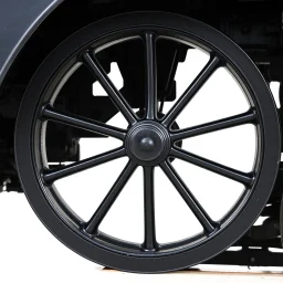 isolated image of a spoked steel wheel(black) from a steam train. vignette of just the wheel