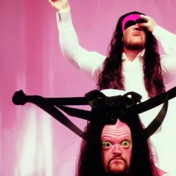 the undertaker wearing a pink bow on his head